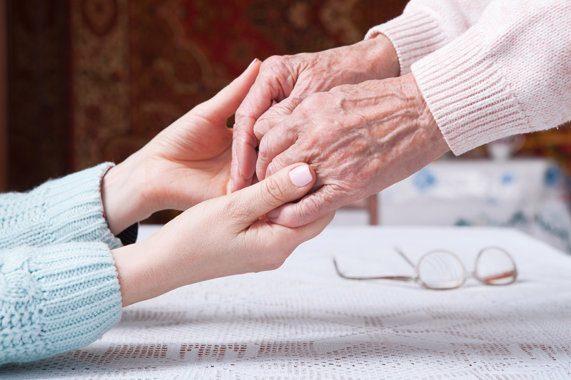 elderly hands holding younger hands