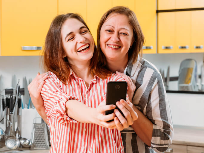 modern technology happy mother daughter selfie